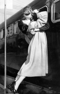 Apr. 28, 1952: Sgt. 1st Class Owen Marsh of North Hollywood leans out bus window to pick up his wife Evelyn for kiss before going to Fr. MacArthur after landing at airport. He will be discharged there.